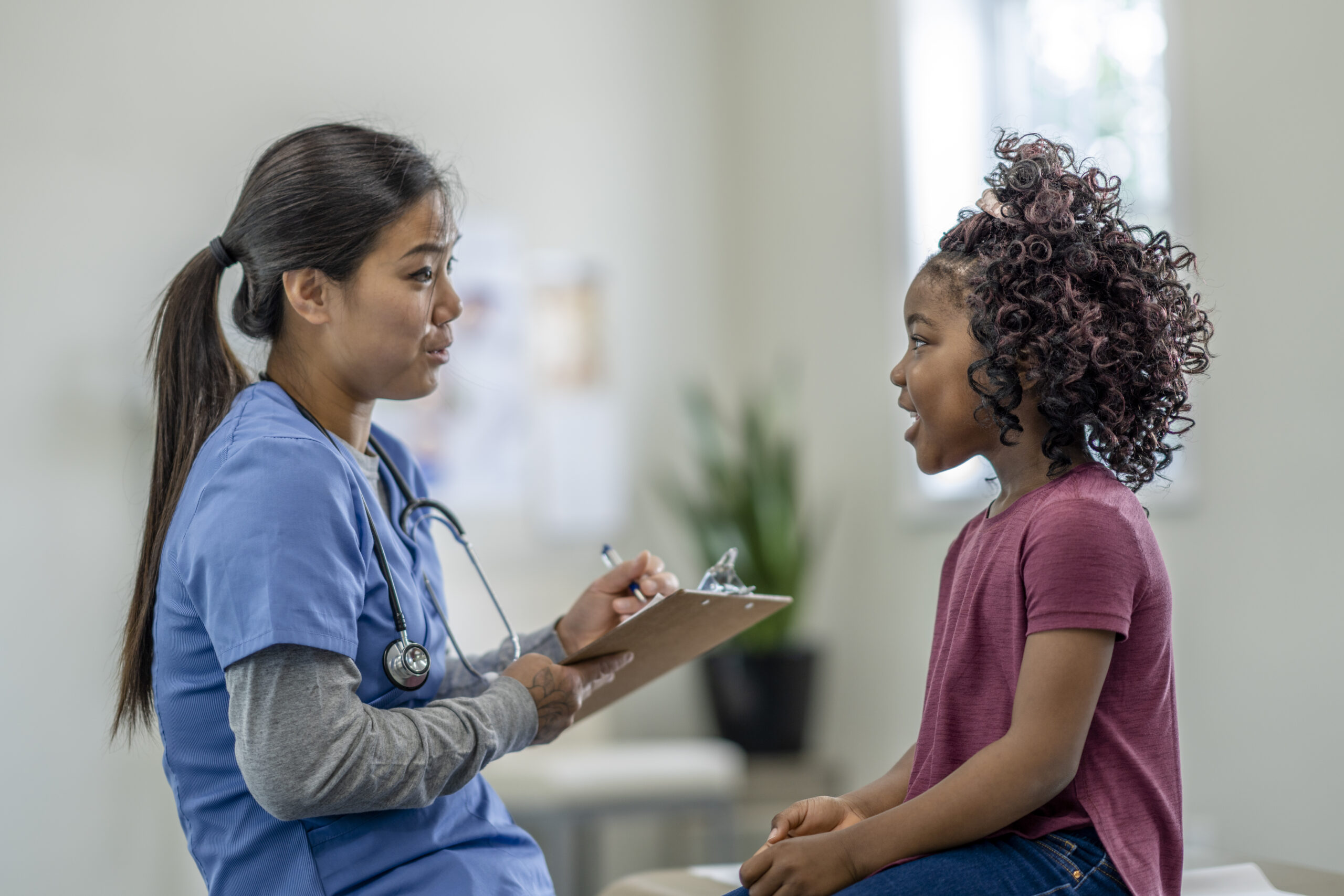 A nurse talking to their young patient.